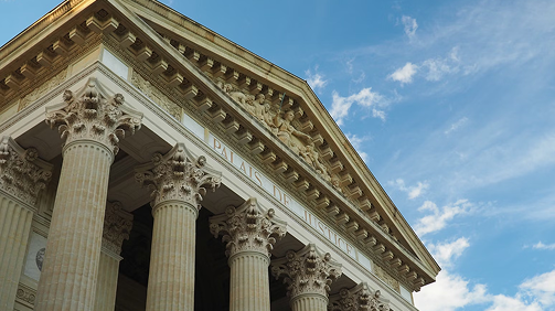 Ein Foto von einem Gerichtsgebäude, das Straf- & Schadenersatzrechtsschutz der Rechtsschutzversicherung symbolisiert.